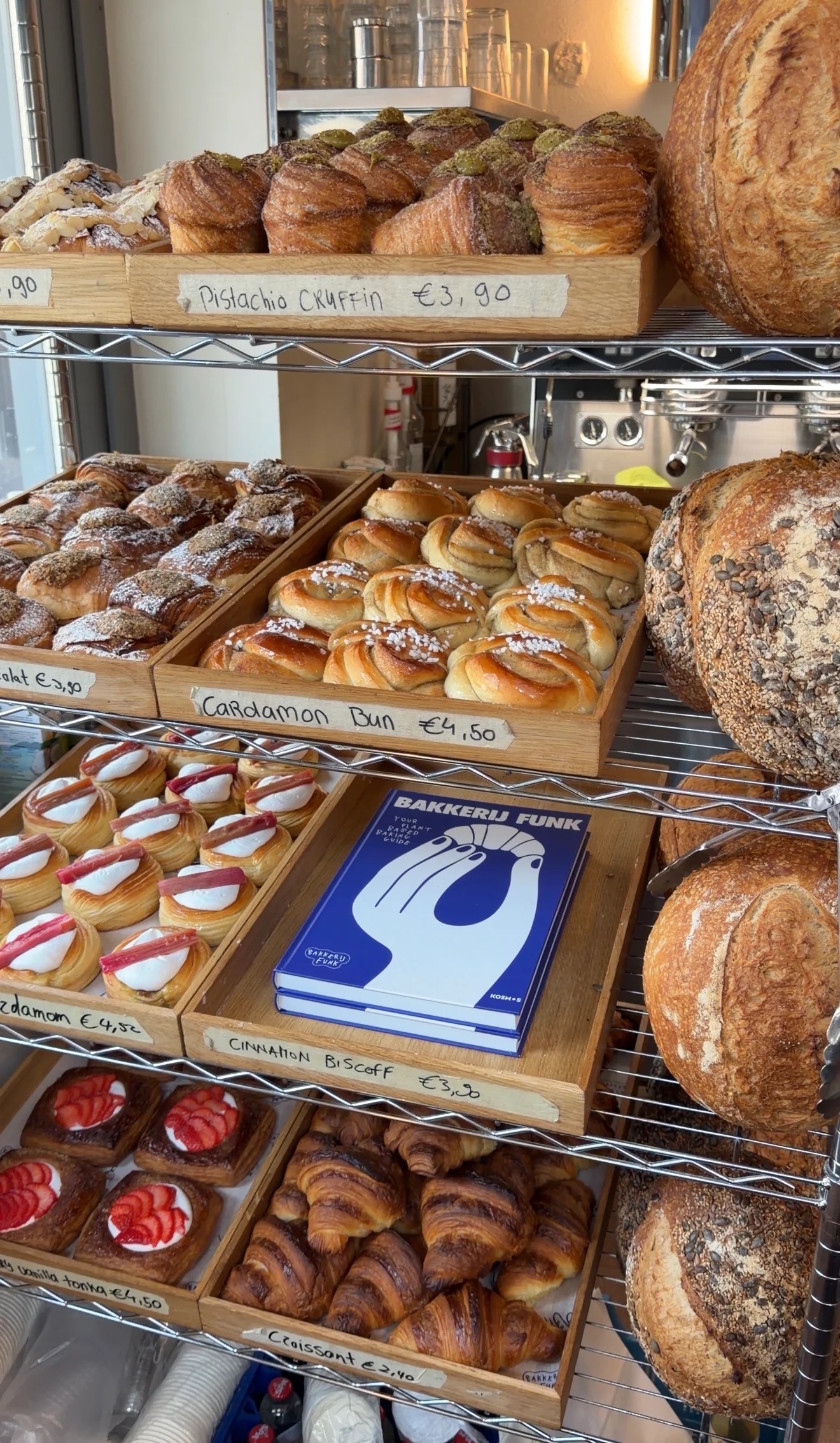 The bakery counter shelves filled with cruffins, buns, tarts and the Bakkerij FUNK book
